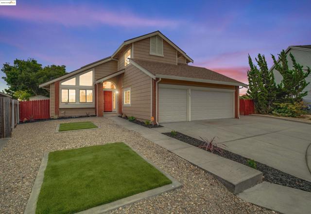 View of front of property featuring concrete driveway, roof with shingles, and a garage