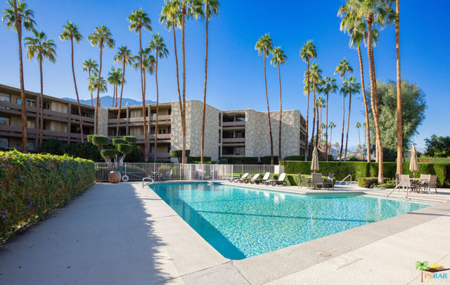 Welcome to The Diplomat. Perfectly located in the heart of South Palm Springs, a few minutes away from the nightlife of downtown Palm Springs, Cathedral City, and Rancho Mirage. This spacious 1,850SF condominium (no common walls) includes an additional 560SF of patio, and lives like a single family home. This top floor unit is perfectly set up for both indoor and outdoor entertainment, and is a remarkable way to enjoy commanding desert views of both the Santa Rosa and the San Jacinto mountains. Walking distance to Smoke Tree Commons, and to Smoke Tree Village Shopping Center, making every day living convenient for pharmacy, restaurants and shopping. This home is a find and offers a more urbane desert lifestyle. Enter the immaculately maintained grounds secured private 4 acre community (full-time gardener and maintenance superintendent), either through the spacious lobby, or through the subterranean private garage with its dedicated secured parking and elevator. The community offers a large private pool and spa, in the center of its lush greenbelt, with mountain views to the south and west. Also provided through the HOA is cable, internet, and earthquake insurance. The floor plan of this expansive condo boasts 10 feet ceilings and walls of sliding glass doors offering abundant light and impressionable views of the million-dollar neighborhood. Come inside the home through "Hollywood" style double 10' doors into an expansive foyer showcasing brand-new engineered hardwood flooring throughout, leading you to the oversized and open Living and Dining, featuring an iconic Palm Springs wet bar; the kitchen with its breakfast area (also open to a balcony through oversized sliding glass doors); a generous Guest Bedroom with Full Bath; and a massive Master Bedroom en suite, with impressive bath and spacious walk-in closet. Marble-topped vanities in both Master and Guest Bath. The gorgeous kitchen is complete with quality stainless appliances and newly installed quartz countertops, black granite sinks, and new, contemporary tiled backsplash. Out on the Dining area balcony is the laundry and utility closet, with central air conditioner, furnace, and water heater located in the enclosed space. Inside, there's also plenty of closet space for clothing and for storage, in addition to a community secured private "luggage" closet. This condominium is a must-see (and a must-want) to experience a stylish, urban Palm Springs lifestyle. See 3D Virtual Tour, as well as Video Tour (on YouTube, via Property Website link). Please book your private showing today.