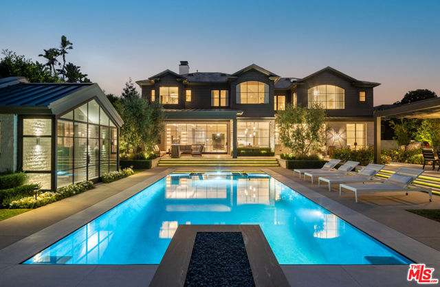 12740 Hanover Street Los Angeles, California This stunning 11,280-square-foot home is the epitome of luxury and sophistication. With interiors designed by renowned Adam Hunter, the estate took 3.5 years to build. Every detail is custom, from the inlaid marble floors to the automated steel doors. The home features a living room adjacent to a lacquered dining room, a fluted three-story staircase, two elegant offices, and an informal family room. The gourmet kitchen is equipped with top-of-the-line appliances and finishes, making it a showpiece that would be the envy of any chef.Upstairs, you'll find a spacious primary bedroom suite with a sitting room, an editorial primary bath with book-matched Calacatta Cielo marble, and dual walk in closets. There are also three additional ensuite bedrooms. The lower entertainment floor is yacht inspired, with a onyx bar and sitting room, screening room with wrapped in custom gray leather panels and blush-colored mohair seating, additional guest suite, oversized laundry, and a wellness center including a plunge pool, sauna, massage room, and gym.The south facing sunny grounds are just as impressive as the interior, with a covered loggia, zero-edge infinity pool, 2 fire features, a pool house, and an alfresco dining pavilion. This is a rare offering that is sure to be the envy of all who see it.