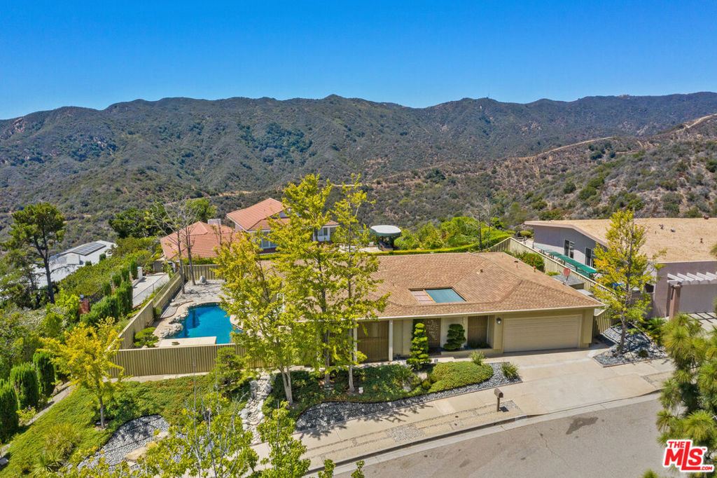 2617 Westridge Road Los Angeles, California Open House Saturday from 2pm to 5pm. Mandeville Canyon home with gorgeous views of Santa Monica Beach all the way to Century City and beyond. Property is being sold by its original owner and is available for the first time in 50 years. This home offers the best of the Westside with a strong Brentwood location that is close to the Brentwood Country Mart, fine dining and trendy shopping on San Vicente, and one of the best public-school districts in LA, all while being removed just enough from Sunset Blvd to offer peace and quiet, and an easy distance to the Westridge Trailhead. Rarely on the Westside of LA can you find views, serenity, and a central location. This 3 Bedroom/2 Bathroom home features a California Zen facade that continues into the open-air atrium with waterfall. Living room is spacious, has large windows that allow for lots of natural light, built in custom wood cabinetry that fits a large screen TV, and boasts the well-manicured Bonsai trees in the backyard. Separate dining area fits an 8-person table and overlooks the sun-filled atrium. Kitchen was recently redone with custom wood cabinetry, exquisite turquoise stone countertops, high-end stainless-steel appliances, a fully integrated refrigerator and freezer, tons of storage space, a large central island, vaulted ceilings with recessed lighting, and a breakfast area. Backyard patio directly off the kitchen offers plenty of space to entertain, make your own, and add furniture. Stone walkway leads to the Don Burgess pool with jacuzzi, and breathtaking views. Custom floor to ceiling hallway organizer with pull-out drawers is a unique feature and offers lots of storage space. Primary bedroom is spacious, offers direct views of the Westside, and has recessed lighting. En-suite primary bathroom has a dual sink vanity, its own closet, and lots of storage space. Secondary bedrooms can easily be converted to become offices and offer plenty of sunlight. Secondary bathroom also has a dual sink vanity as well as a shower/tub combination encased with glass sliding doors. Two car garage is spacious and houses the washer/dryer units. Enjoy a Prime Brentwood location in a house with remarkable views, a spacious pool, and tons of potential to create your own ideal home.
