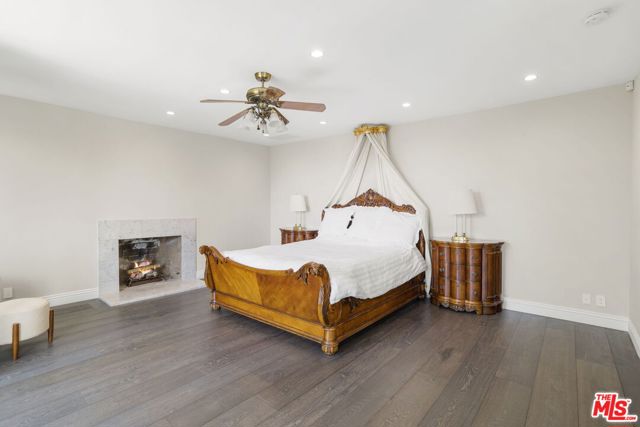 Primary suite bedroom w/ fireplace