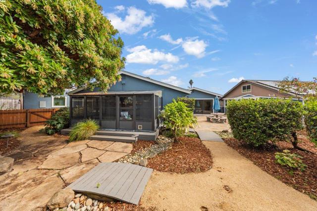 Rear yard looking towards the house, patios and walkways, dry creek, hot tub room off of primary. 